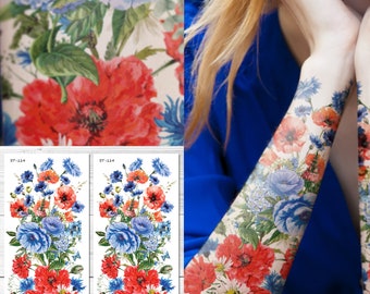Puede incluir: Tatuajes florales temporales con amapolas rojas, acianos azules y margaritas blancas. El diseño incluye el texto "ST-114". Los tatuajes se muestran en un brazo y como hojas individuales, mostrando la vibrante obra de arte al estilo acuarela.