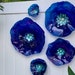jenshepard reviewed Dark Blue/ Eggplant Purple flowers wall art durable recycled plastic looks like glass indoor outdoor wall hanging boho wall decor