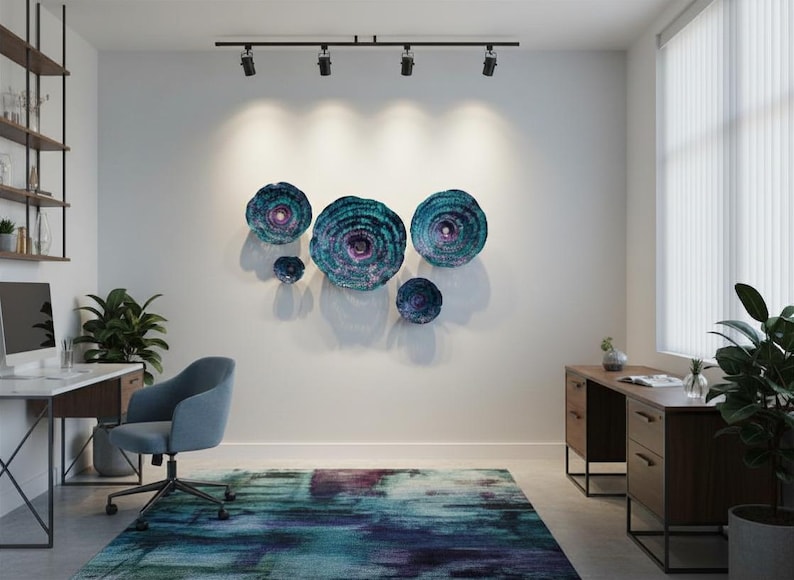 May include: A set of five circular wall sculptures featuring concentric rings in shades of teal, blue, and purple with a textured finish. The pieces are arranged in a cluster on a white wall above a desk and a blue and purple abstract area rug.