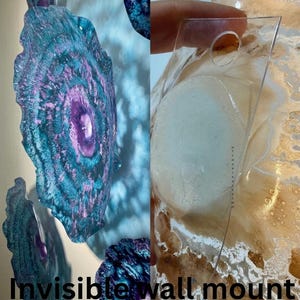 May include: A set of circular wall art pieces featuring swirling patterns of deep teal, blue, and purple hues. The right side shows a clear, transparent acrylic mounting bracket with a circular hole, labelled as an invisible wall mount option.