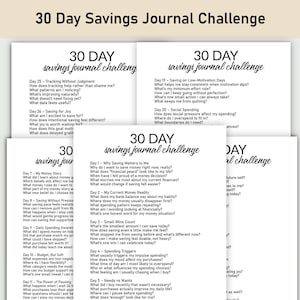 May include: A stack of white paper journals with the text "30 DAY savings journal challenge" in a handwritten style. Each journal page contains prompts for daily savings and financial planning. The journals are designed to help track and improve financial habits.