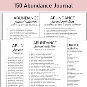May include: A collection of white paper journals with black text, titled "150 Abundance Journal." Each journal features prompts for self-reflection on topics like receiving, time, and mindset. The journals are designed to encourage gratitude and positive thinking.