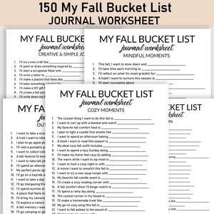 May include: A pile of white journal worksheets with black text. The top sheet reads "150 My Fall Bucket List Journal Worksheet." Other sheets have titles like "Creative & Simple Joys" and "Cozy Moments," with fill-in-the-blank prompts.