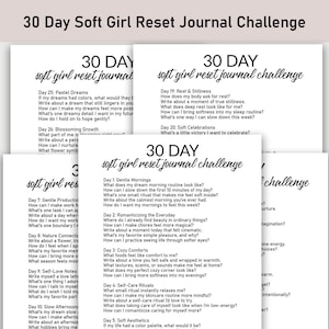 May include: A stack of white paper pages with the text "30 Day Soft Girl Reset Journal Challenge" in a handwritten font. Each page contains prompts for self-reflection and journaling, encouraging personal growth and well-being.