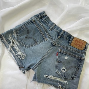 Vintage Levi’s ripped jean shorts size 30