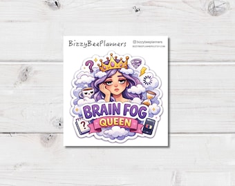 May include: A sticker featuring a cartoon illustration of a woman with purple hair wearing a gold crown, surrounded by clouds and symbols. The text "Brain Fog Queen" is displayed on a banner. Additional elements include a coffee cup, question marks, and a smartphone.