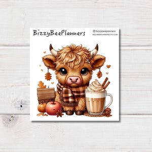 May include: A square print featuring a cartoon Highland cow wearing a scarf, with a pumpkin, apple, and a latte. The print includes the text "BizzyBeePlanners" and the Etsy shop's URL.
