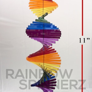 May include: A rainbow-colored acrylic wind spinner with a spiral design. It measures 11 inches tall and 4 inches wide.  EXAMPLE! All pieces are made to order.