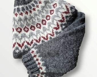 May include: A gray and white knitted sweater with a red and white geometric pattern. The sweater has a long sleeve and a crew neck.