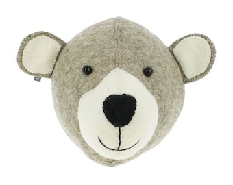 May include: A gray felt bear head wall decor with black eyes and a black nose. The bear has white felt ears and a white felt muzzle.