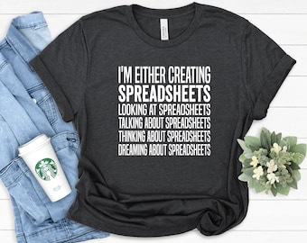May include: A dark grey t-shirt with white text that reads "I'm either creating spreadsheets, looking at spreadsheets, talking about spreadsheets, thinking about spreadsheets, dreaming about spreadsheets."