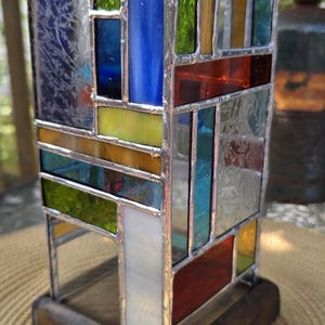 Stained glass hurricane style candle holder with wooden base