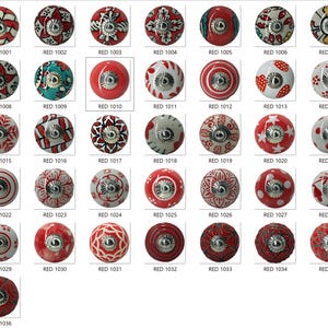 May include: A collection of red and white ceramic cabinet knobs with various patterns, including floral, geometric, and polka dots. Each knob has a silver-toned metal base. The text "RED" followed by a number is printed below each knob.