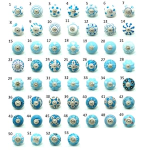 May include: A collection of 53 ceramic cabinet knobs in various shades of blue and white. Each knob features unique patterns and designs, including floral, dotted, and geometric motifs. The knobs have silver-toned metal bases.