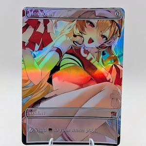 May include: A rectangular holographic trading card titled Mox Ruby featuring an anime-style character in a red and white cheerleader outfit. The card displays the text Artifact and the ability to add red mana to a player's mana pool, with a zero cost symbol.