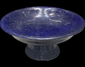 May include: A large, blue, decorative bowl made of lapis lazuli. The bowl has a wide, round base and a flared rim. It is a beautiful and unique piece of art.