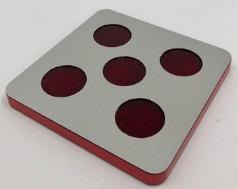 May include: A square, silver-colored prop with five circular, dark red insets. The prop has a red border and the text "OPLE Props" is in the upper left corner. The website address www.opleprops.com is in the lower right corner.