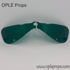 May include: A dark green, curved plastic prop with a central hole and two smaller holes. The prop has a reflective surface and is labeled "OPLE Props" at the top and "www.opleprops.com" at the bottom.