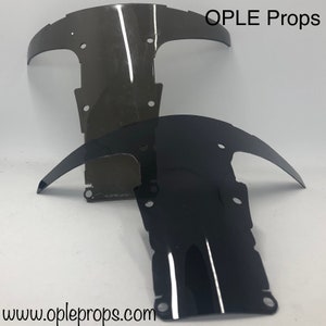 May include: Two motorcycle windshields, one black and one clear, with OPLE Props text and website address.