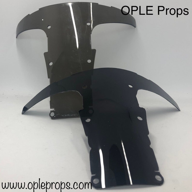 May include: Two motorcycle windshields, one black and one clear, with OPLE Props text and website address.