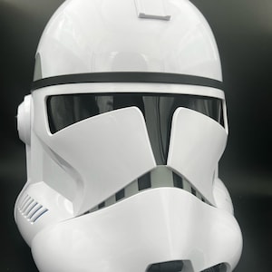 May include: A white plastic Star Wars Clone Trooper helmet with a black visor and a black stripe across the top.