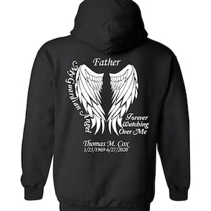 May include: Black hooded sweatshirt with white text and angel wing graphic. The text reads "Father", "My Guardian Angel", "Forever Watching Over Me", and the name "Thomas M. Cox" with dates.