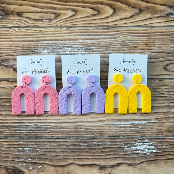 Textured Polymer Clay Arch Earrings. Available in three colors: cadmium yellow, lilac purple and rose pink.