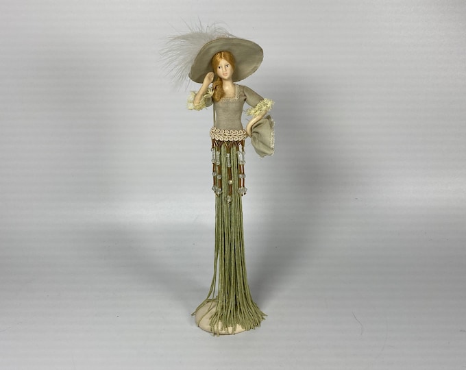 Victorian 11" tall tassel doll in a soft pastel green, wide brim feathered hat and holding handkerchief