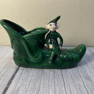 Pixie sitting on a shoe/boot/slipper flowerpot