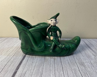 Pixie sitting on a shoe/boot/slipper flowerpot