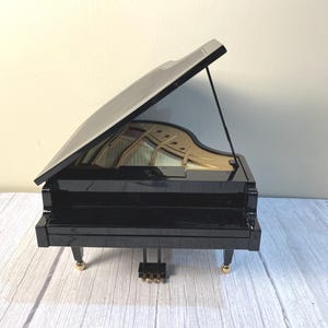 Vintage black Wonderland tabletop battery or electric musical grand piano