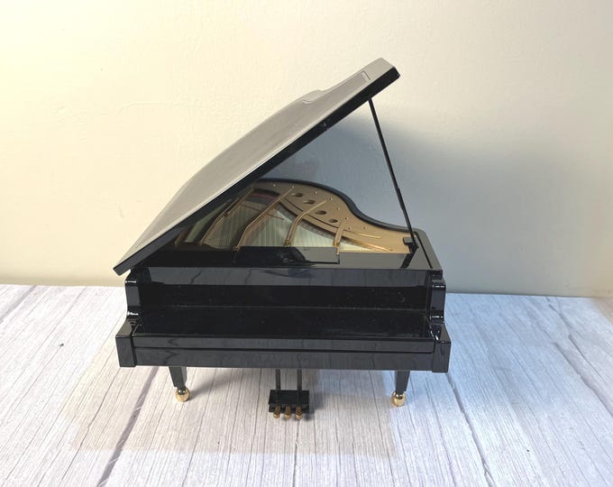 Vintage black Wonderland tabletop battery or electric musical grand piano