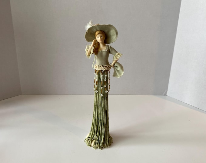 Victorian 11 1/4" tall tassel doll in soft moss color dress and tassel with lace trim.