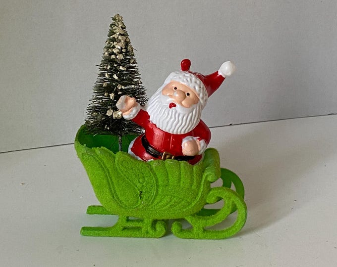 Vintage Celluloid Santa Claus on Green Flocked Sleigh with vintage Christmas Bottle Brush Christmas Tree