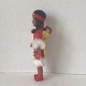 1960s Sleepy Eyed Plastic Native American Indian Woman with Twin Babies carried on her Back Souvenir Indian dolls