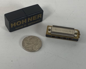 Vintage Germany Hohner Little Lady Miniature Diatonic Harmonica in the key of C with its original black plastic case.