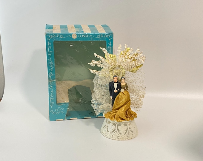 Vintage Coast Novelty 50th Wedding Anniversary Cake Topper w/ Gray Hair Couple in front of 50th Wedding Background with gold accents & tulle