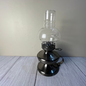 Pewter colored metal finger oil lamp with key bubble chimney and wick