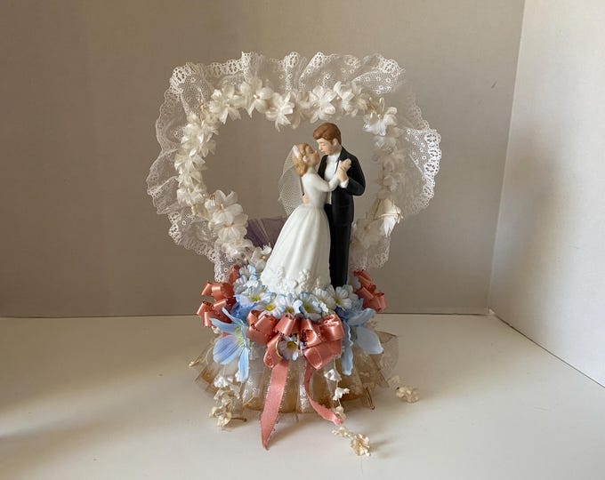 Vintage Ceramic Bride  Groom Cake Topper with white, blue, peach, purple floral and ribbon  accents and with Lace, floral heart background