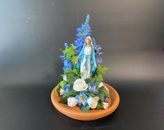 Mary Madonna with Open Arms surrounded by White and Blue Flowers on Terra Cotta Base.