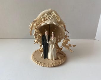 1948 J. Levinsohn Co. Wedding Cake topper with Chalkware Bride and Groom, Bell and platform accented with Faux flowers and ribbon