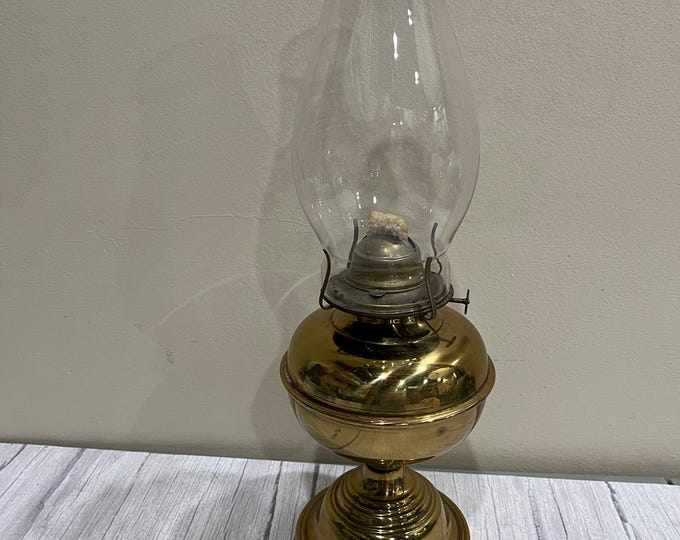 Vintage large brass pedestal oil lamp with clear chimney and wick