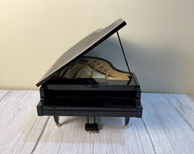 Vintage black Wonderland tabletop battery or electric musical grand piano