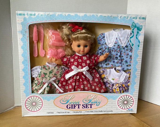 1990 Sweet Sally Soft Body Vinyl Arms & Legs Sleepy Eyes Baby Doll with 4 outfits, comb, brush, curlers and toy in original box