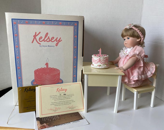 Turning 1 Years Old-Kelsey at the table ready to blow out her candle/Cake spins playing Happy Birthday-by Joyce Reavey Georgetown Collection