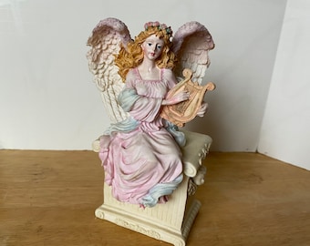 Music Box Seraphim Angel Style sitting on bench with cherubs on it playing "The Music Box Dancer"