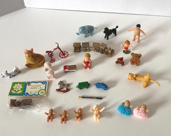 28 piece miniature dollhouse accessories including  dolls,  flocked animals,  toys, 3plastic animals and a stuffed cat