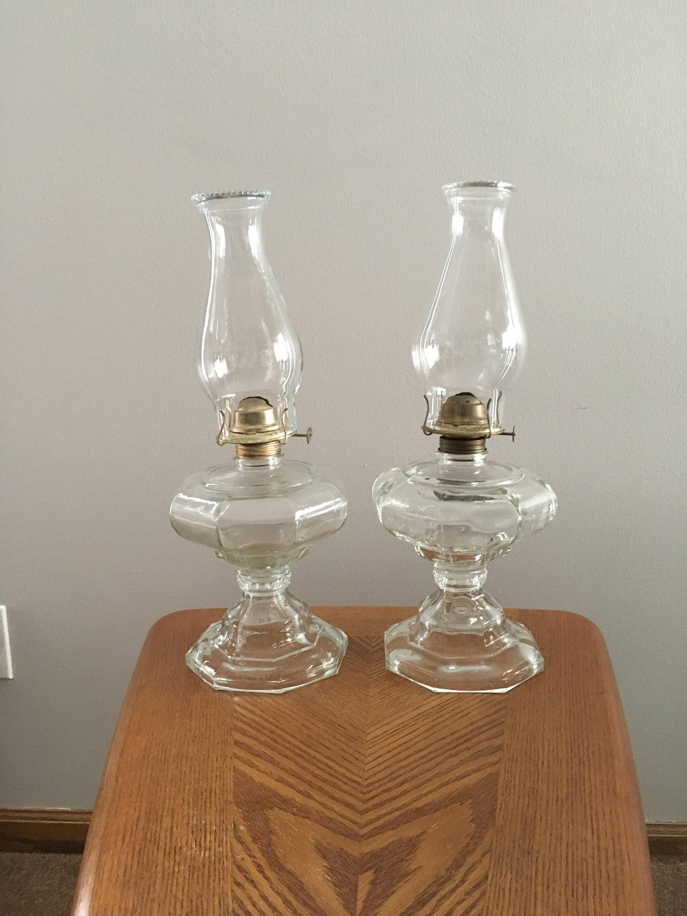 Vintage pair of oil lamps with chimneys