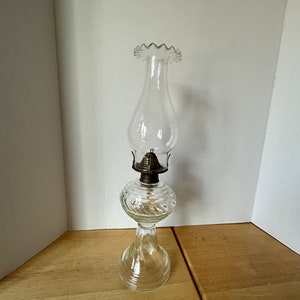 Vintage round swirl clear glass oil lamp with clear fluted chimney and wick