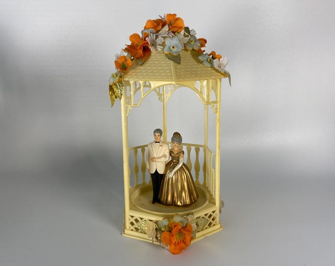 Vintage  50th Wedding Anniversary Cake Topper w/ Gray Hair Couple inside Plastic Gazebo accented w/ Blue & Orange Flowers